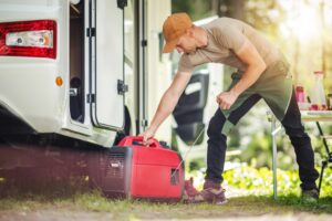 Men Firing Portable Inverter Generator Connected to His Motor Home - electrician New Orleans - B powered Electric