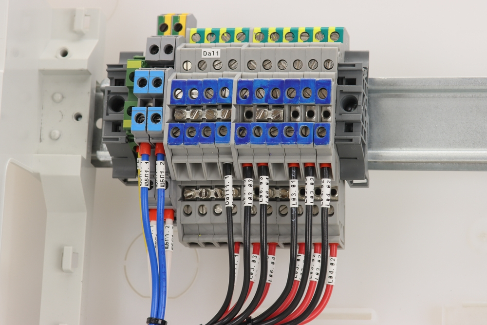Electrical transmission terminals for connecting insulated copper wires in a switchboard, showcasing circuit design as per commercial electrical codes in New Orleans.